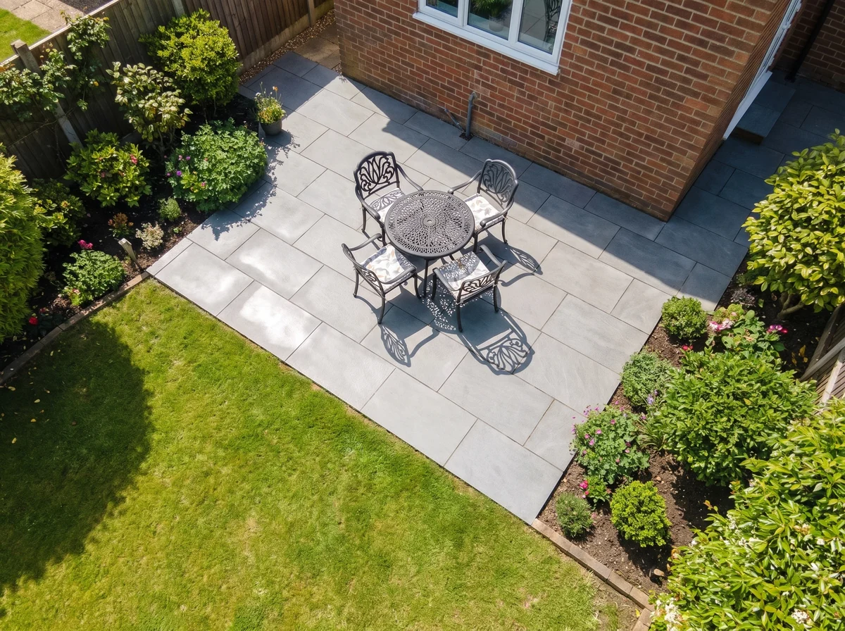 Aerial view of a small freshly cleaned grey-slab patio in a Surrey back garden